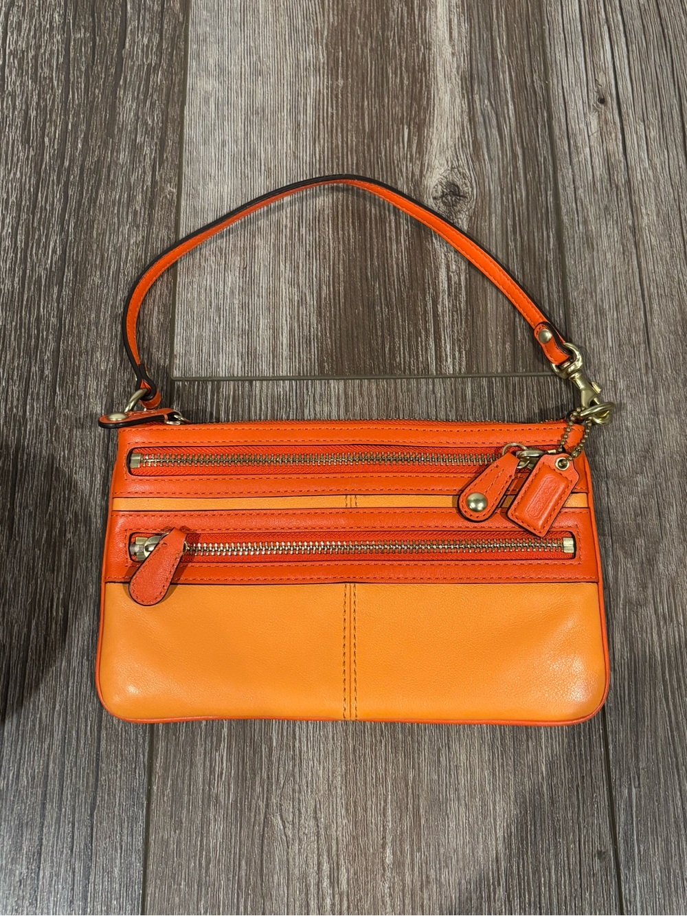 Vintage orange leather Coach wristlet from the Bonnie collection